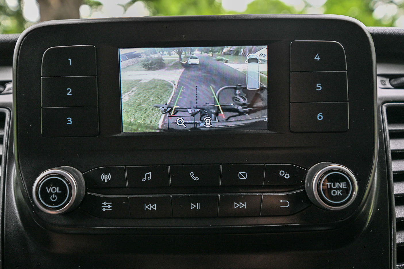 RV rental infotainment: Backup camera view with parking assistance, showing a bike rack. Helpful for safe maneuvering.