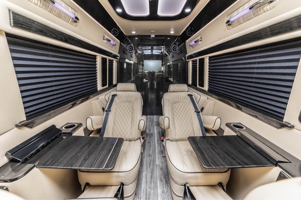 and wood-look flooring visible through an open door.|This silver Mercedes-Benz Sprinter luxury van