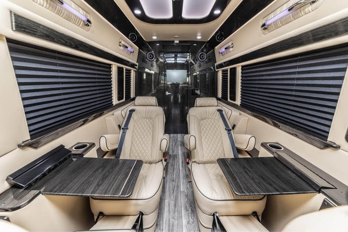 and wood-look flooring visible through an open door.|This silver Mercedes-Benz Sprinter luxury van