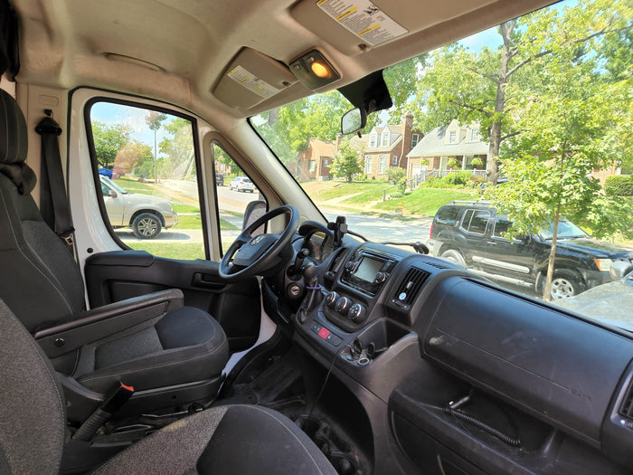 and stylish wood details.|White RV rental camper van parked on a sunny beach road