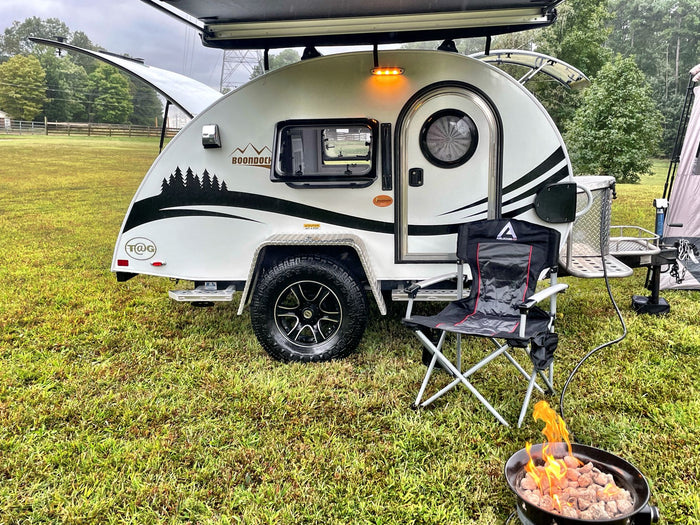 ready for camping on green grass.|This T@G Boondock rv rental features an impressive rear outdoor kitchen with a sink