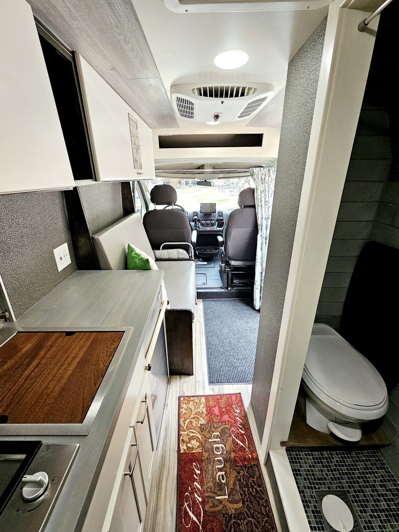 parked on a gravel road.|White Ram ProMaster camper van on a gravel road — photo 11