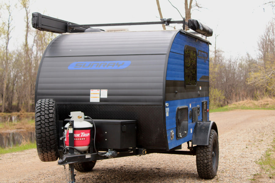 Black & blue Sunray teardrop trailer, perfect for your next RV rental adventure. Equipped with propane & spare tire.