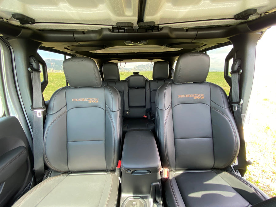 Spacious Jeep Rubicon 392 interior with black leather seats, open roof, and mountain views. Perfect rv rental.