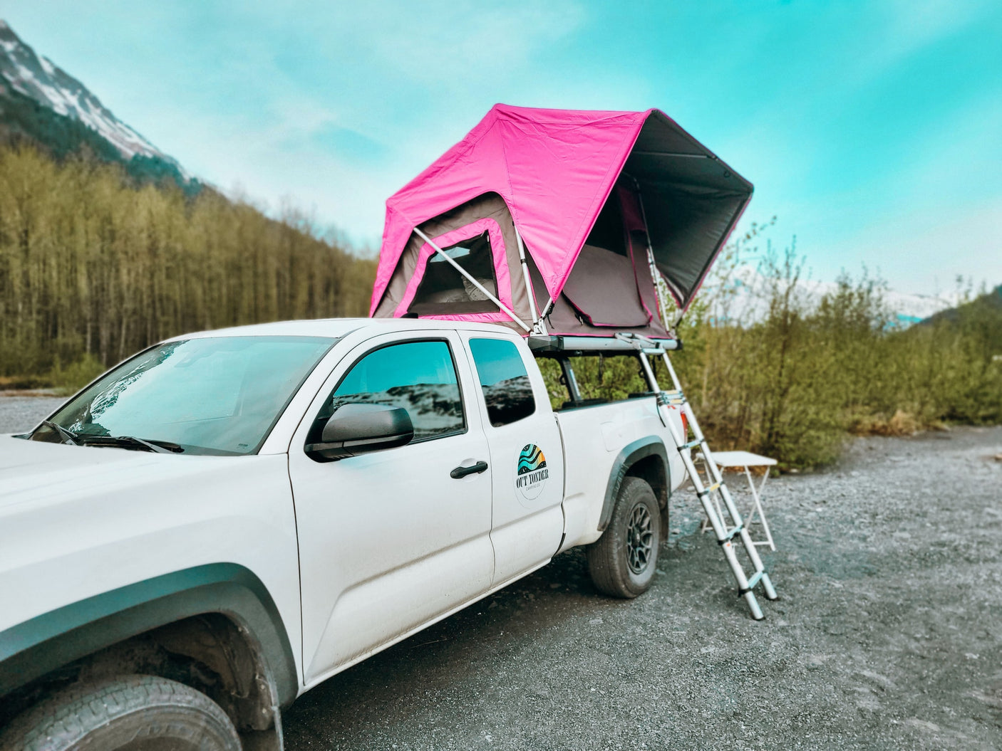 White truck with pink rooftop tent