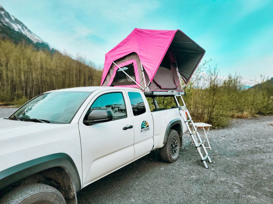 White truck with pink rooftop tent