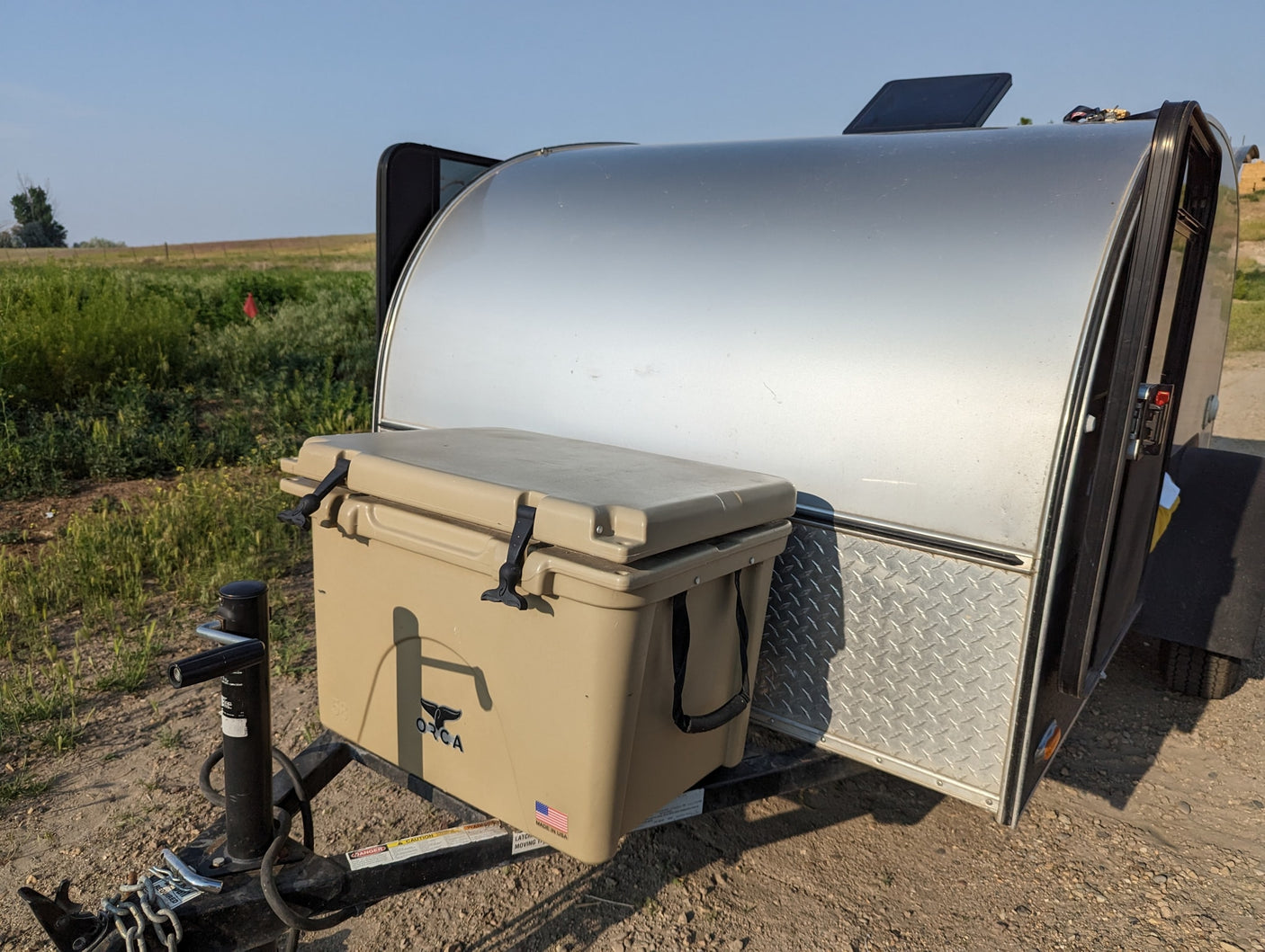 and a picturesque field view.|This modern gray teardrop RV