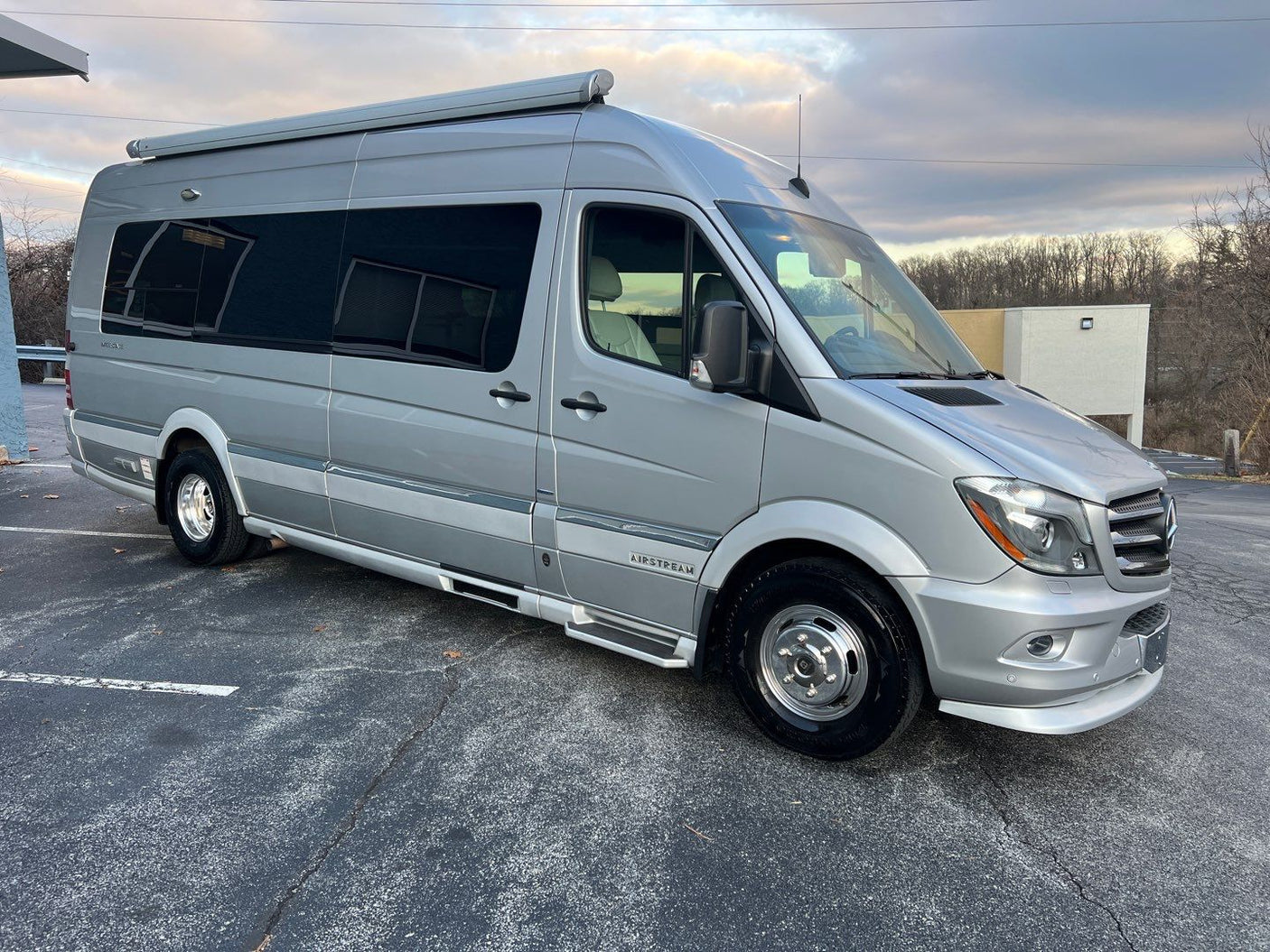 Silver Airstream RV rental: a modern camper van parked, ready for adventure and travel.