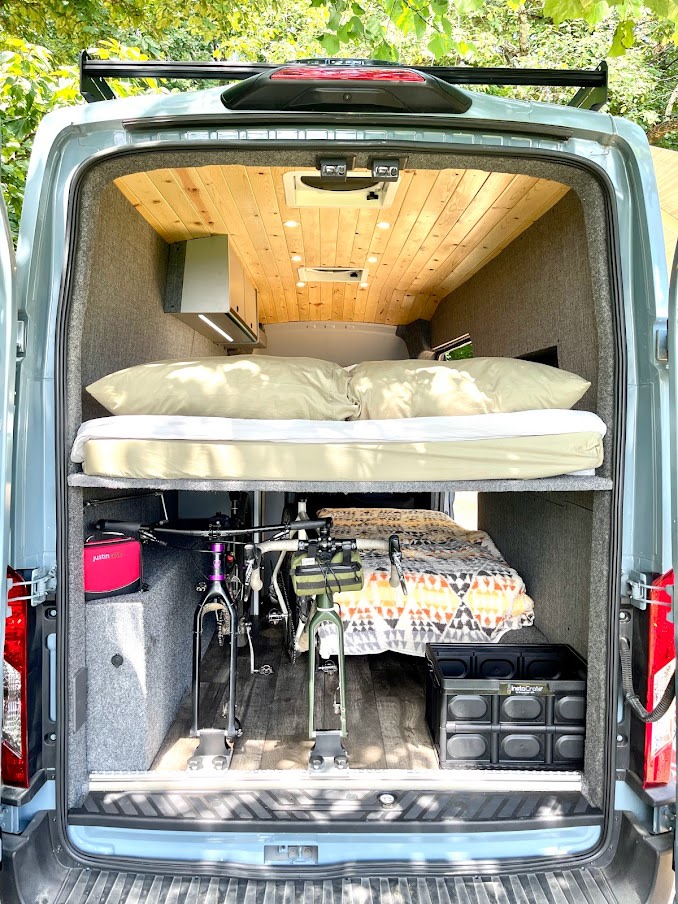 and bed. Ready for your next journey!|Explore this spacious RV rental interior: wood ceiling