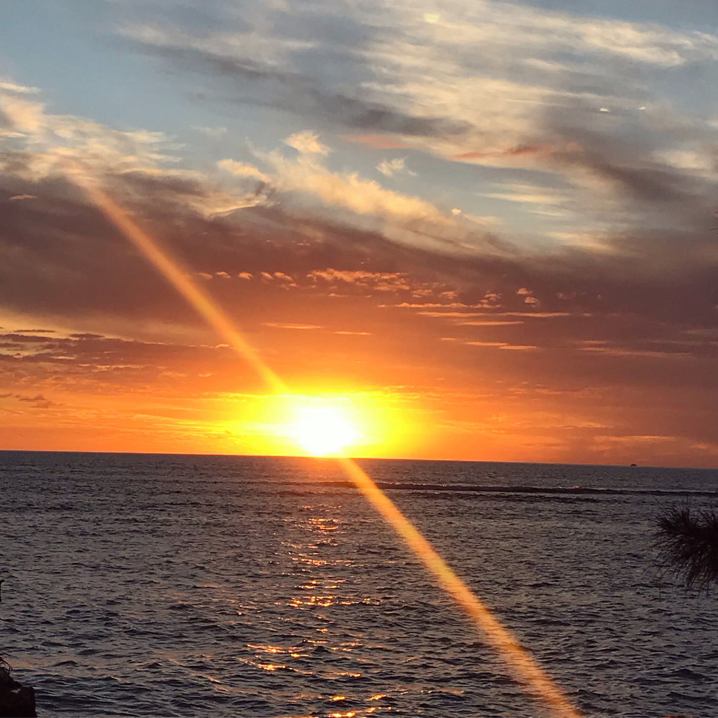 Stunning ocean sunset with sunbeams, perfect for an RV rental adventure. Experience scenic travel.
