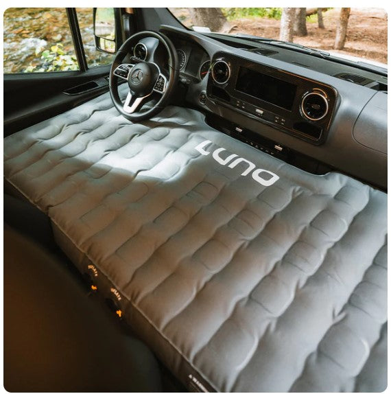 RV rental camper van's front cabin converted into a sleeping area with a LUNA air mattress.