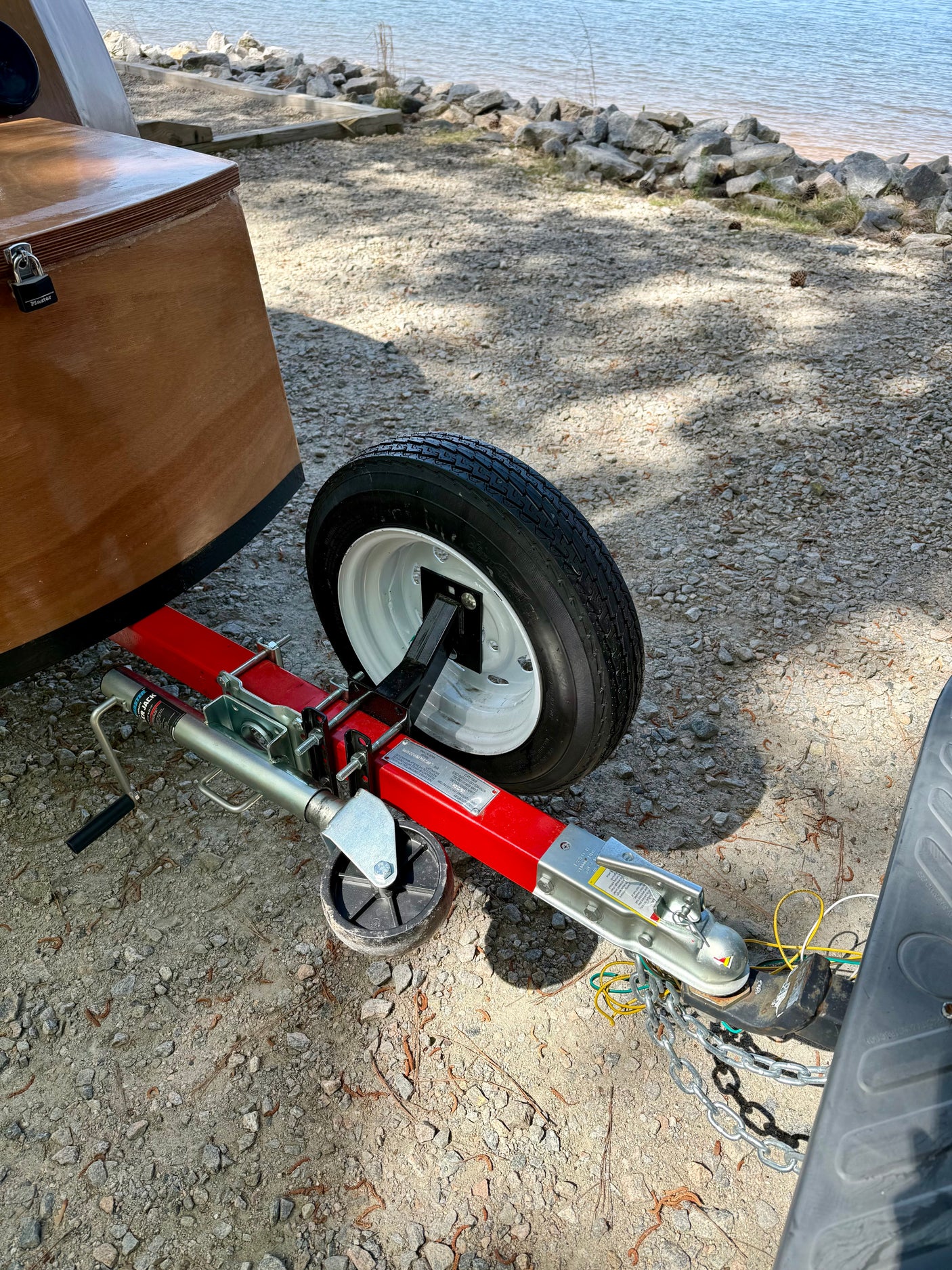 Small boat trailer prepped for travel, attached to an RV rental. Ready for a waterfront adventure!
