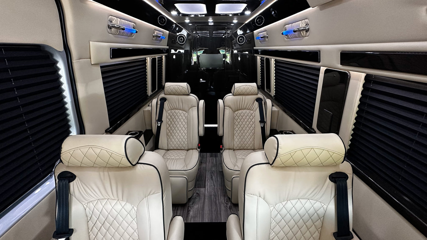 Luxury RV rental interior with cream leather seats, black accents, privacy blinds, and blue ambient lighting. — photo 3