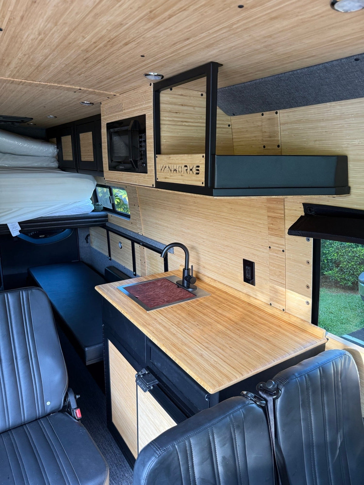 and cozy wood paneling for trips.|Modern Mercedes-Benz rv rental interior — photo 6
