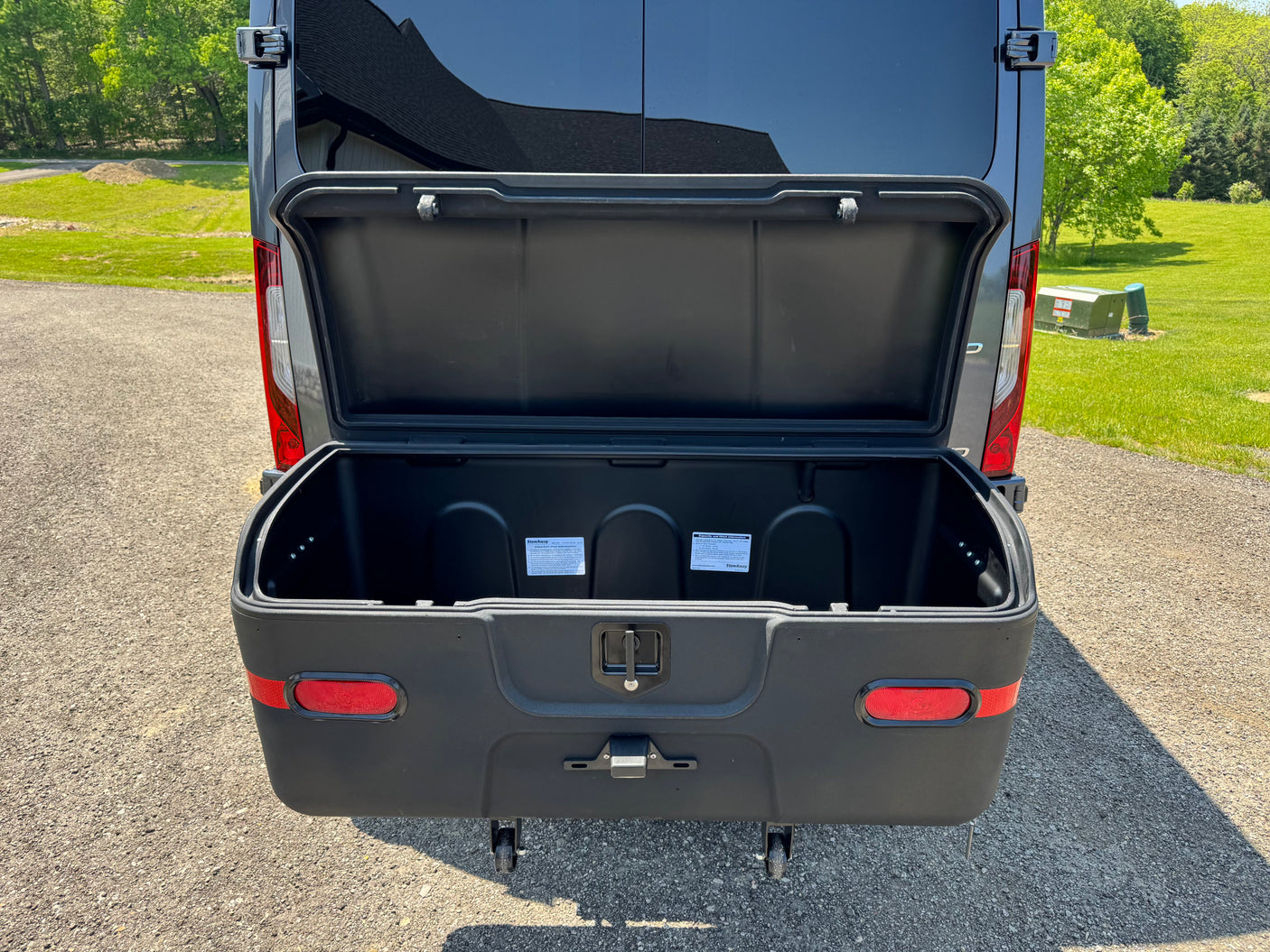 Open StowAway cargo box on an RV rental. This hitch-mounted exterior storage unit adds valuable space.