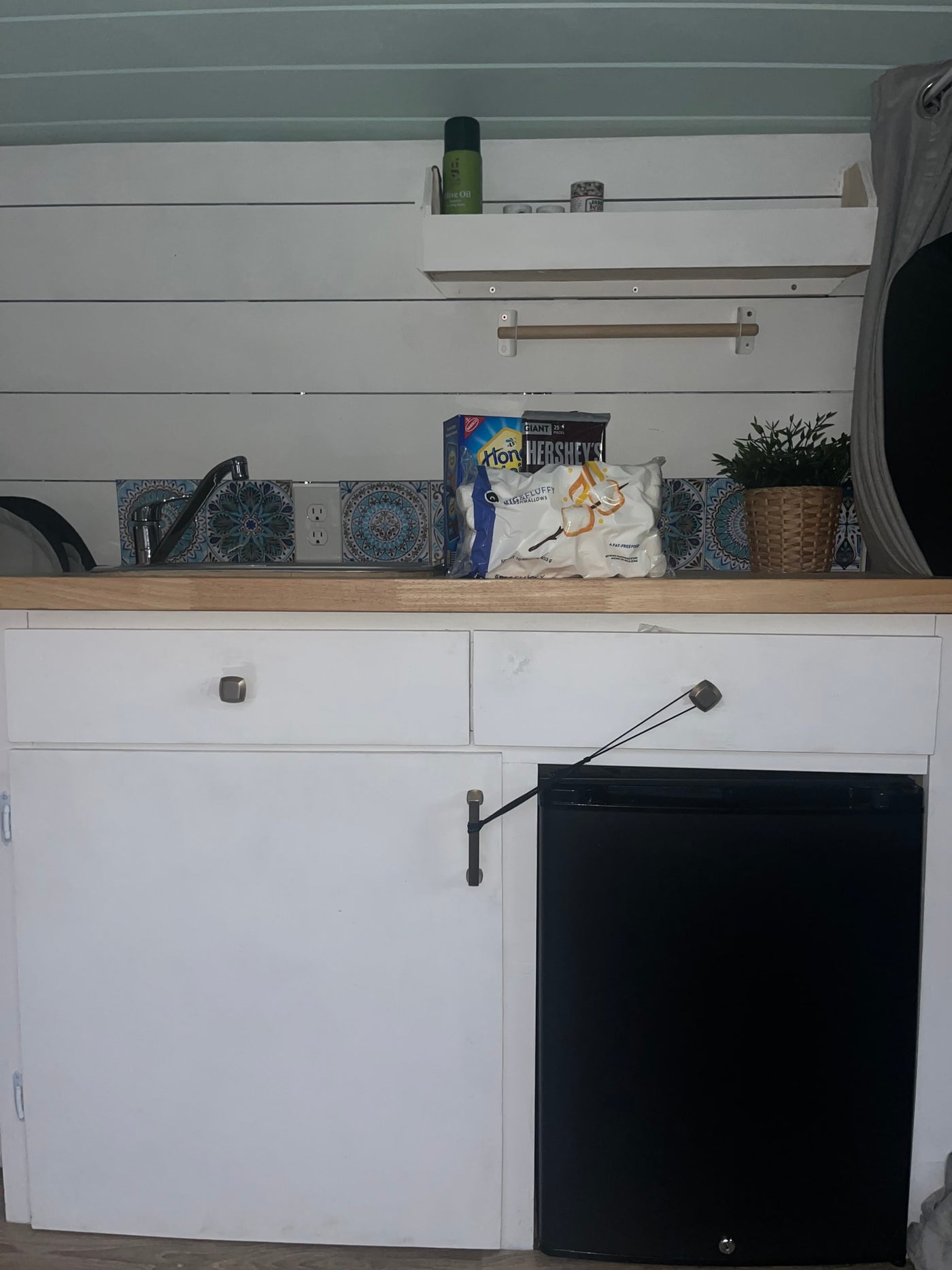 Compact rv rental kitchen with s'mores supplies, sink, and mini-fridge, ideal for road trips. — photo 12