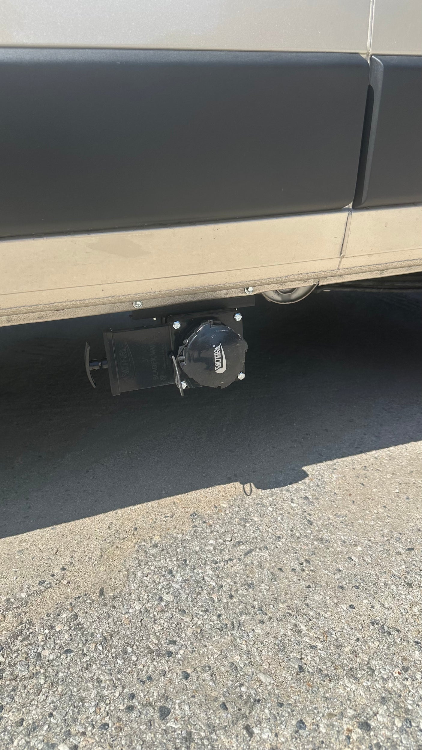 RV rental's undercarriage showing Valterra waste water dump valves, essential for sanitary disposal.