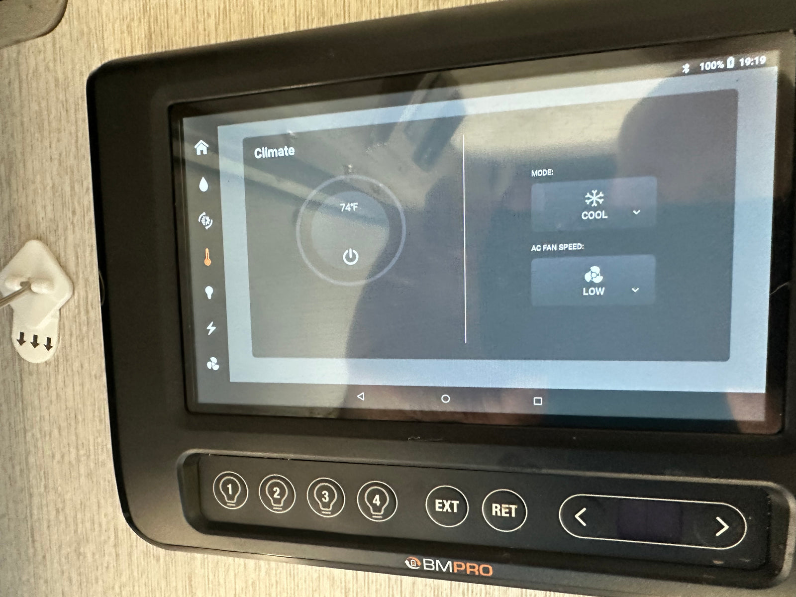 This RV rental's BMPRO smart panel displays climate control (74°F, cool, low fan speed) and physical light/function buttons.
