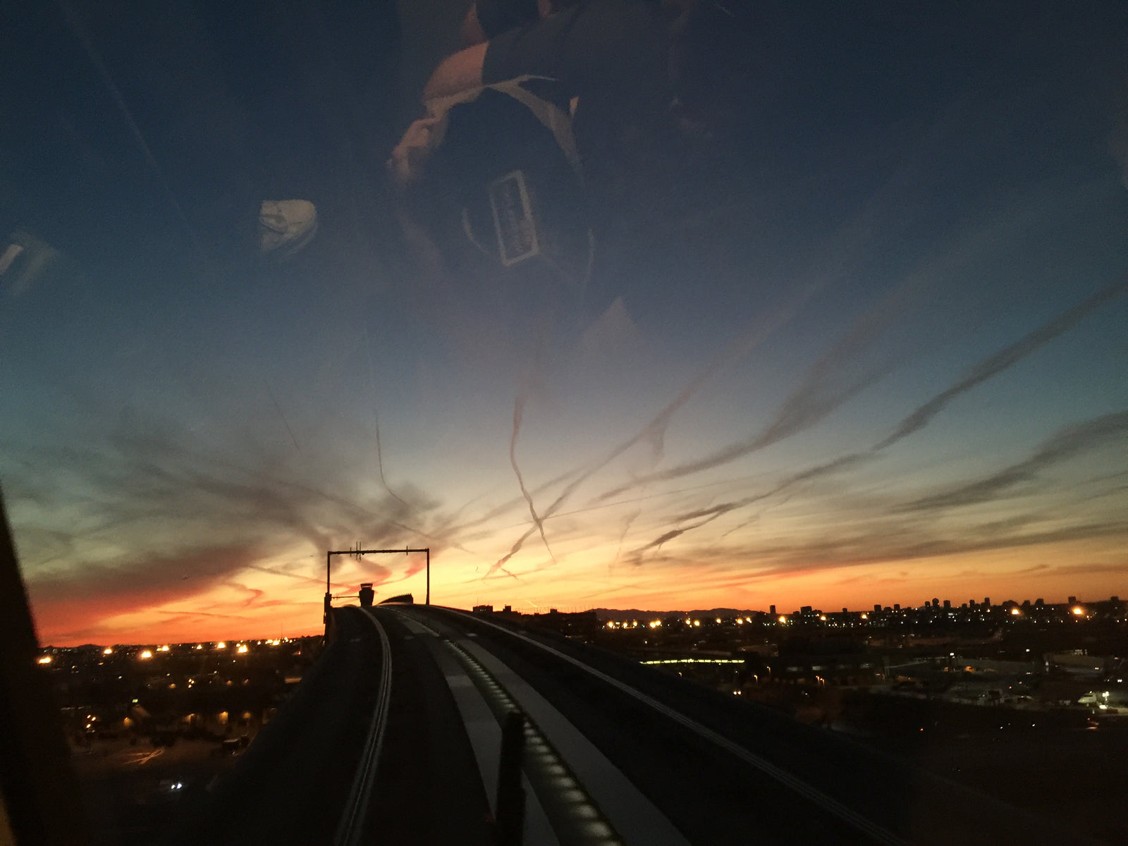 Gorgeous sunset over a city skyline from an elevated track. Perfect scenery for an RV rental trip or any travel adventure.