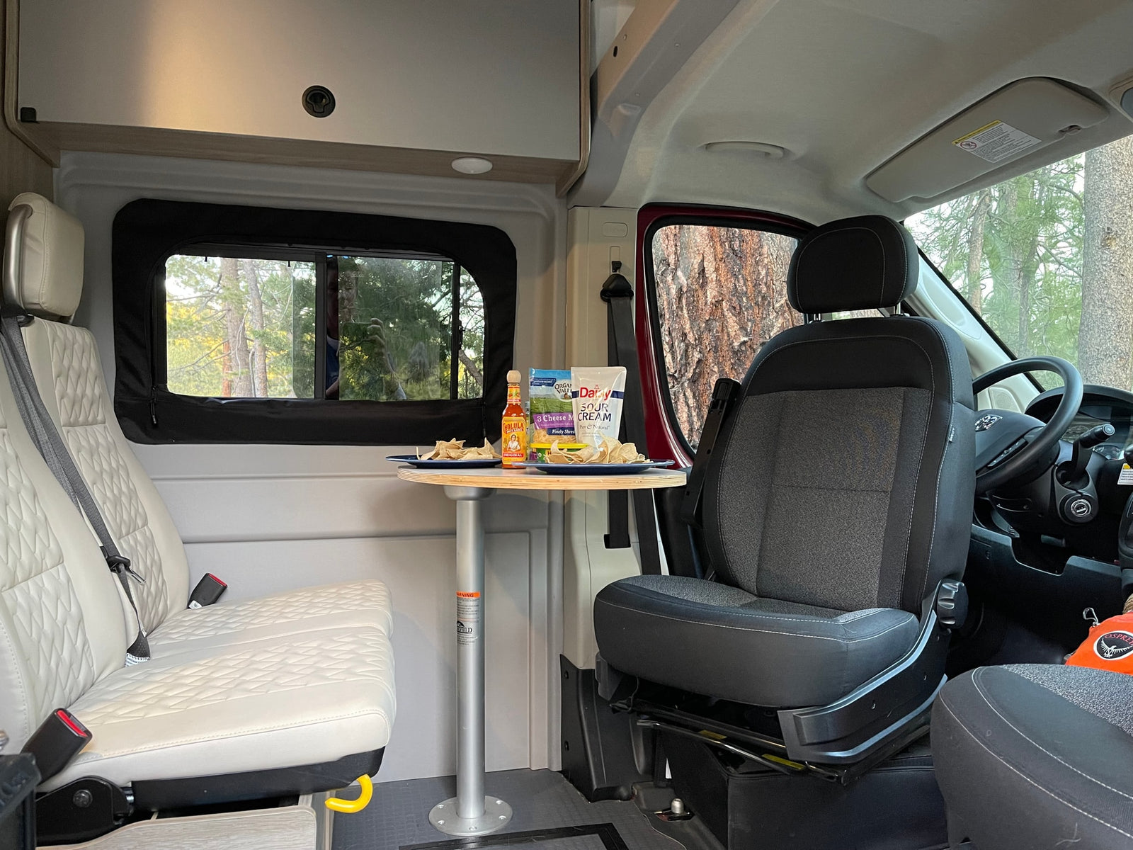 offering an outdoor view. Ideal for **camping**.|Inside a spacious RV rental van