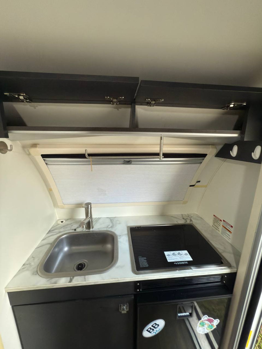 ready for outdoor adventure.|Compact rv rental interior: grey dinette