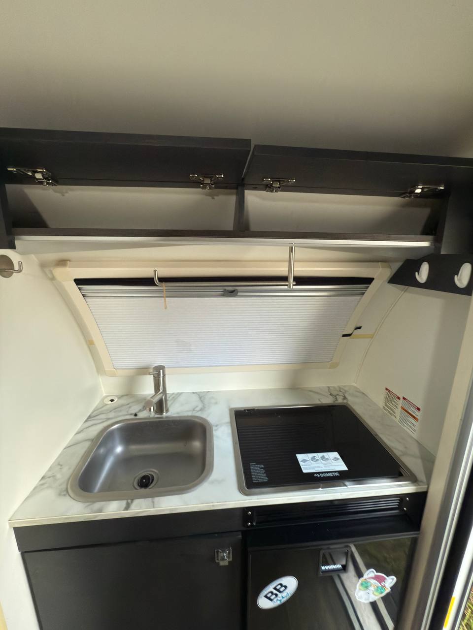 ready for outdoor adventure.|Compact rv rental interior: grey dinette