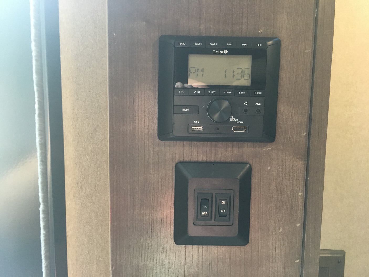 RV rental interior: control panel displaying 11:36 PM with USB/HDMI, plus dual ON/OFF switches for functions.