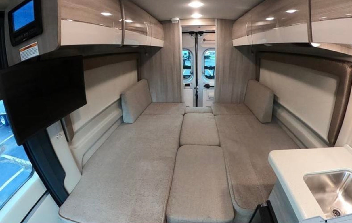 a compact camper van with rooftop AC/solar and external hookups