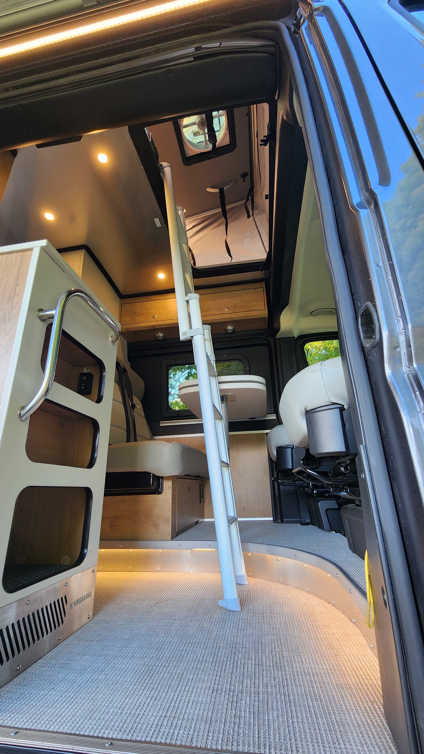 Experience luxury mobile living in this rv rental. A bright camper van interior with dynamic lighting & versatile layout.
