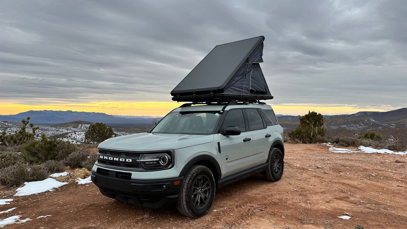 ideal for an rv rental adventure in snowy mountains.|Ford Bronco Sport with rooftop tent