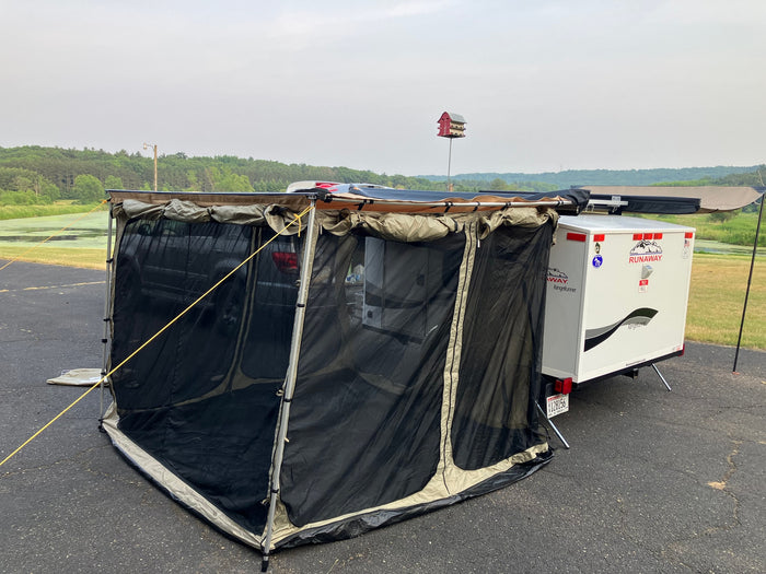 A compact Runaway RV rental, a white camper trailer, is set up with a large mesh screen room attached to a vehicle on asphalt. Ideal for camping.
