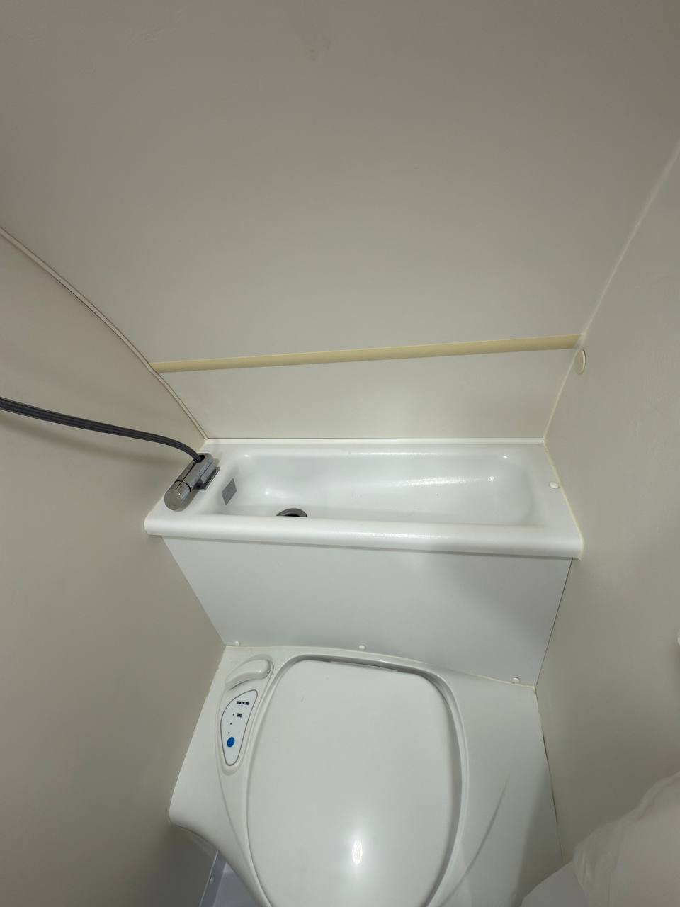 and overhead cabinets for storage.|Compact RV rental kitchenette with sink