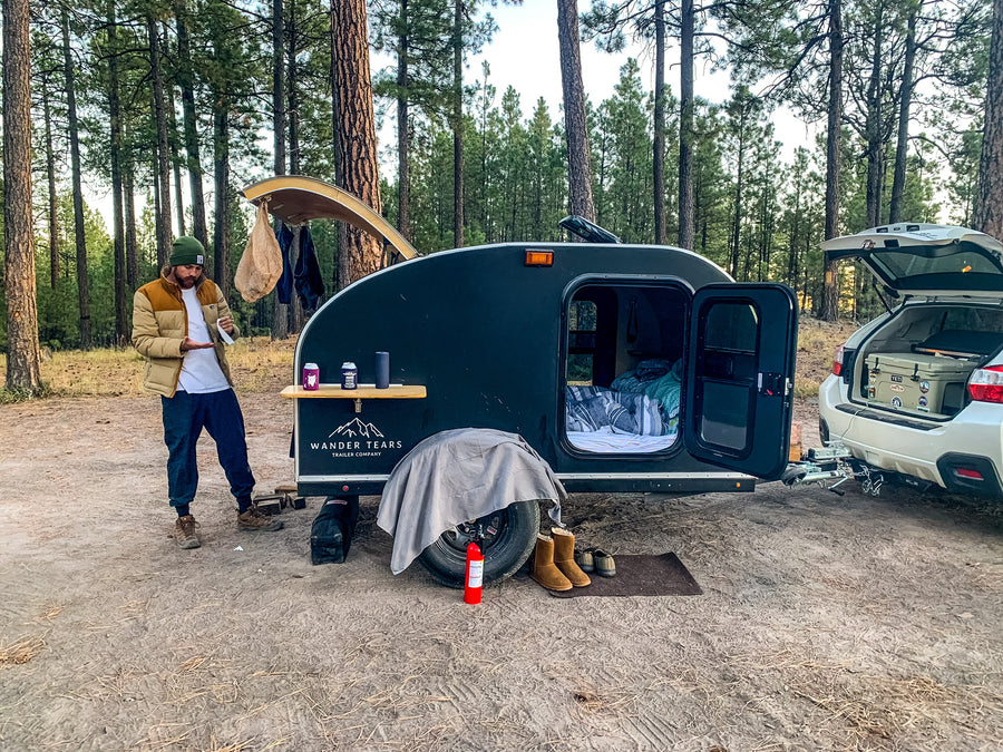 and open door revealing the exterior.|Compact RV rental: Teardrop camper's open rear galley