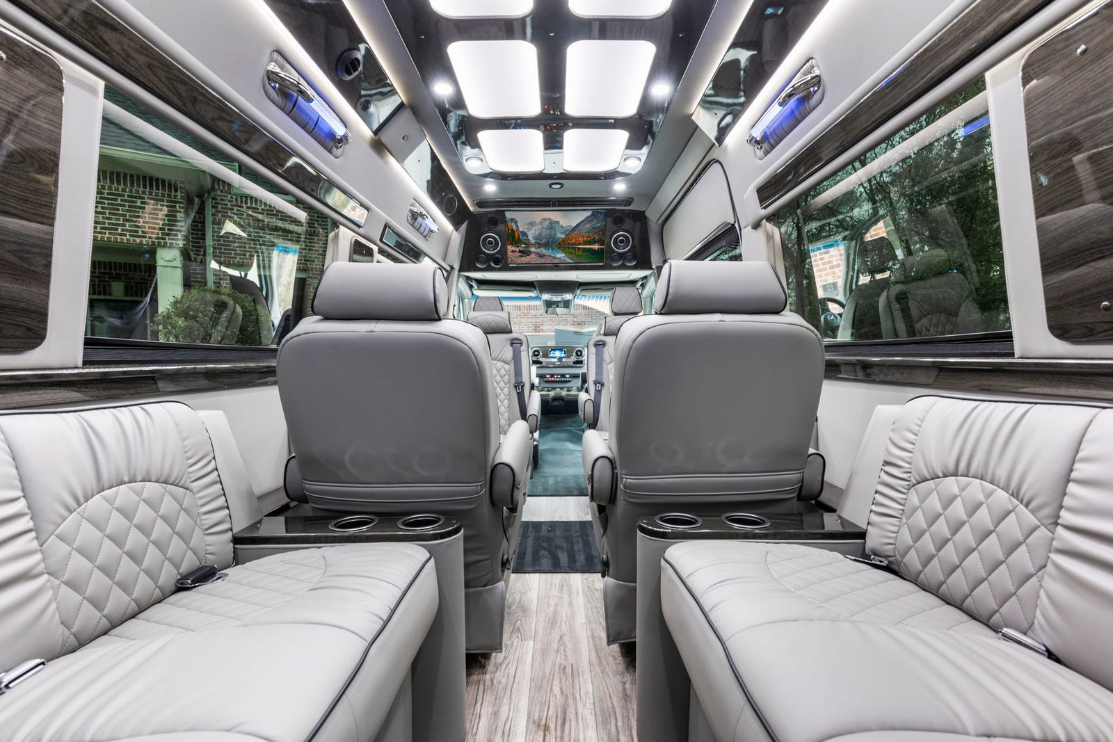 Luxury rv rental interior: spacious cabin, plush seating, entertainment screen, and ambient lighting for comfortable travel.