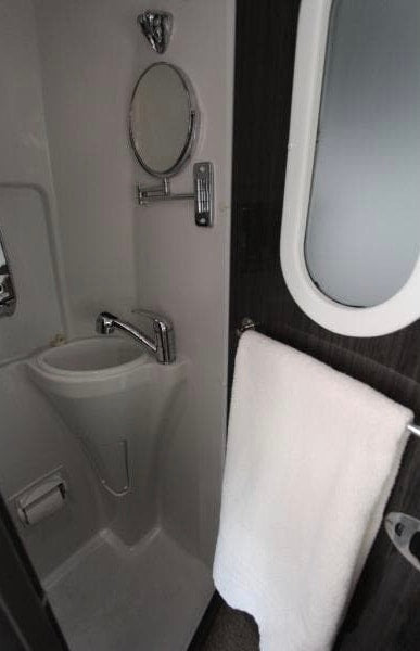 luxurious RV interior with TVs showing football & golf