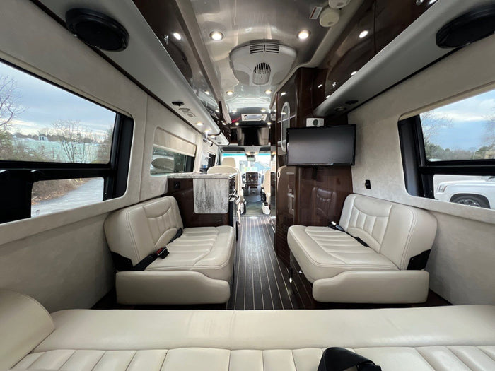 ideal for travel adventures.|Spacious luxury RV rental interior features cream leather seating