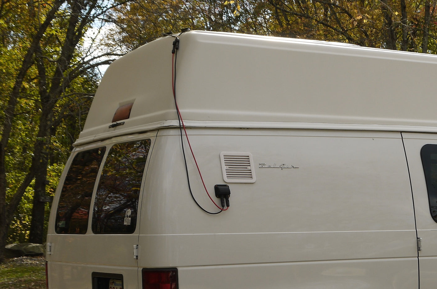 ready for adventure.|A white high-top Ford Econoline camper van