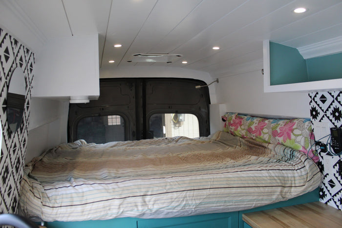 under foreboding dark storm clouds over dry hills.|Inside this **RV rental**