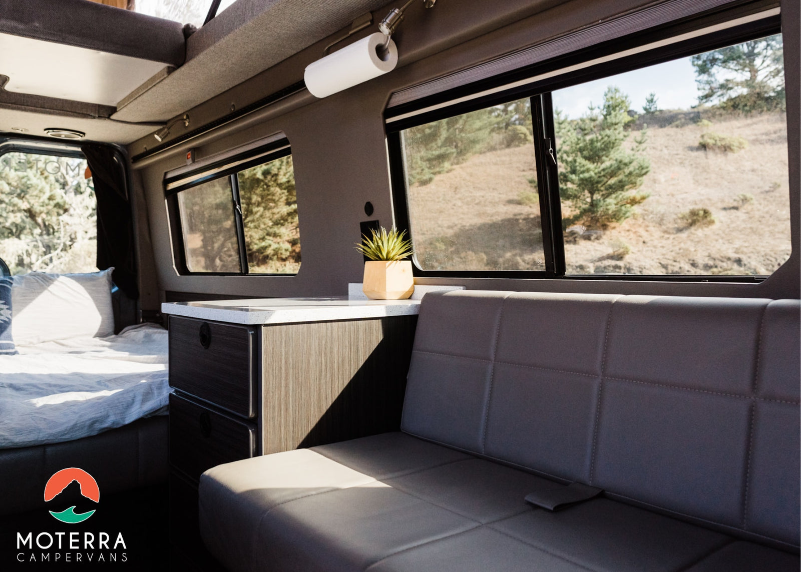 and window with natural landscape views.|Gray RV rental van
