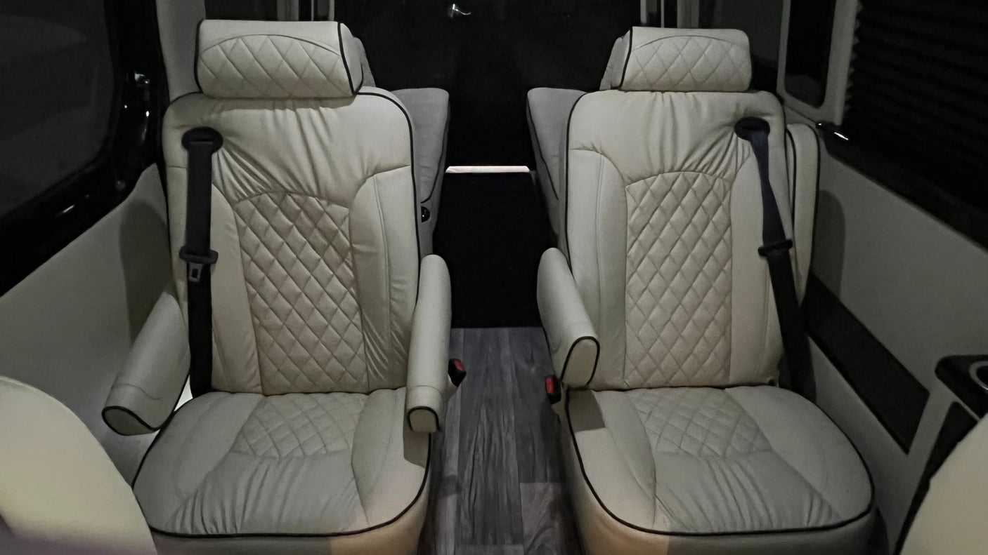 Experience premium comfort in our RV rental! Luxurious cream captain's chairs with diamond stitching and black piping.