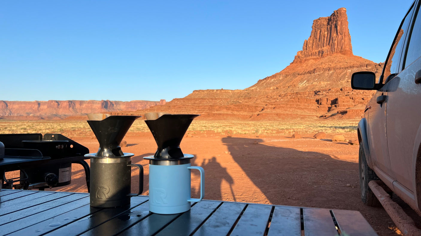 Sunrise pour-over coffee from an RV rental, set against a majestic red rock desert. An ideal outdoor adventure.