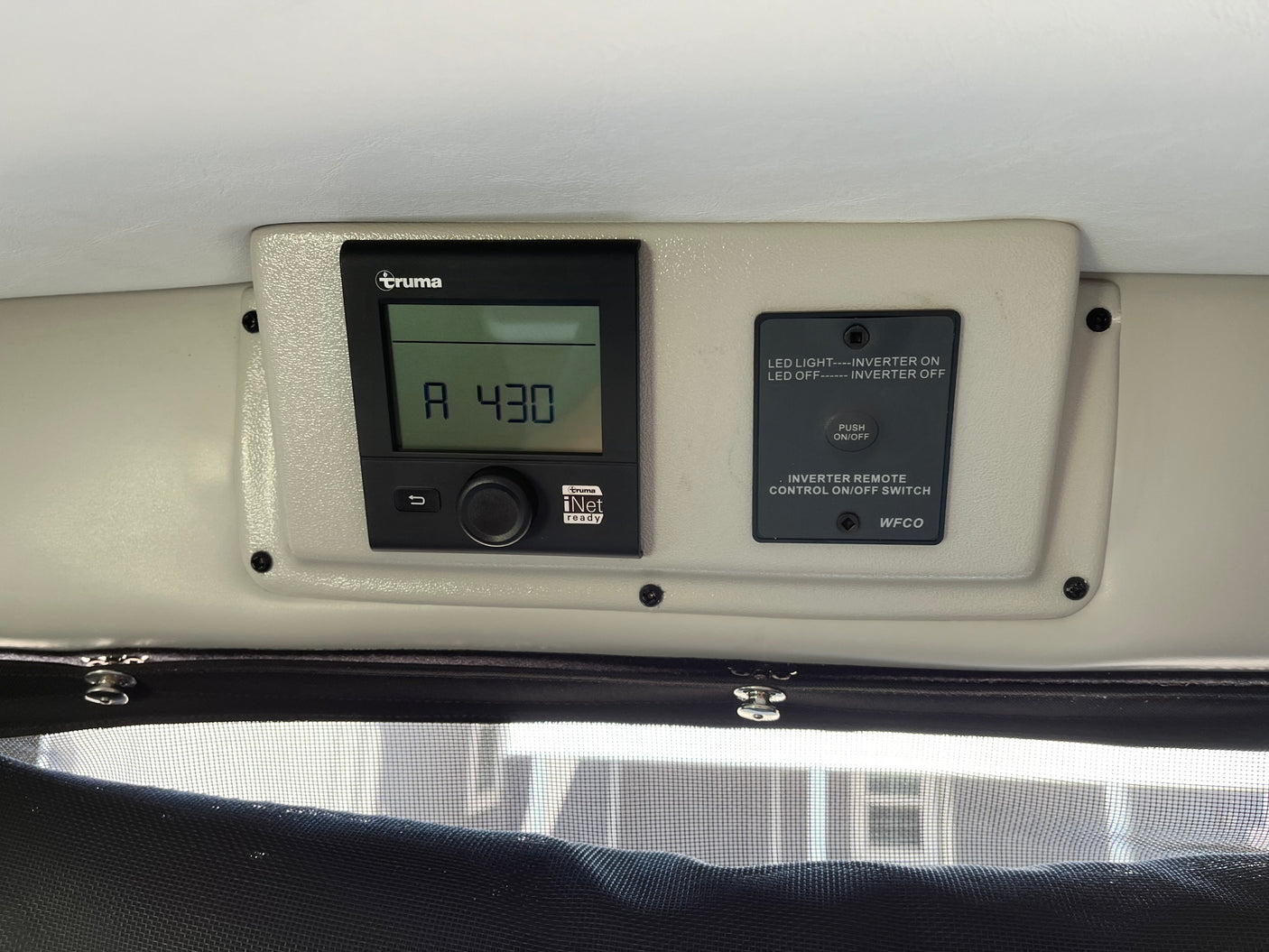 RV rental interior: Truma climate control panel displaying "A 430" and a WFCO inverter remote switch for power.