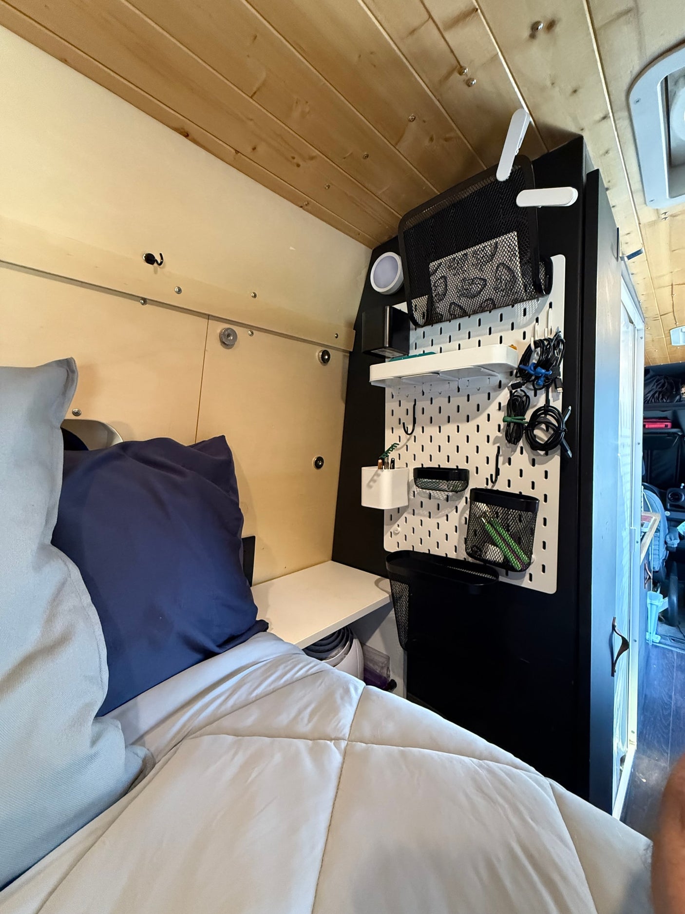 and window shades for privacy. Overhead storage & counter in view.|RV rental interior: organized storage behind a dark curtain