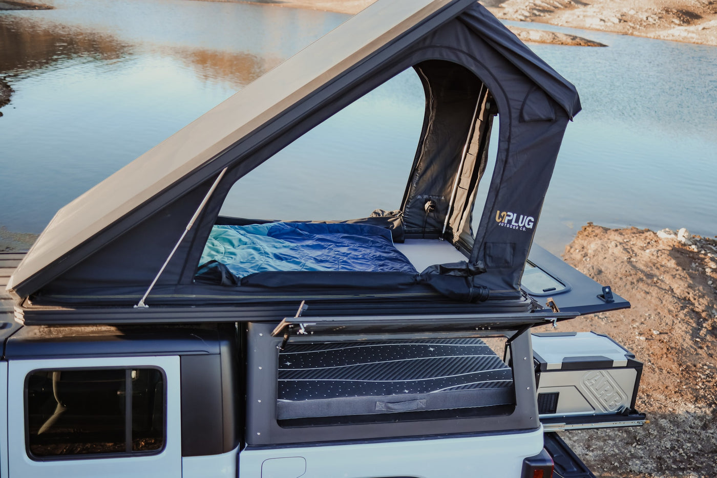 RV rental truck with open rooftop tent & comfy bedding, plus an ARB portable fridge, ready by the lake. — photo 14