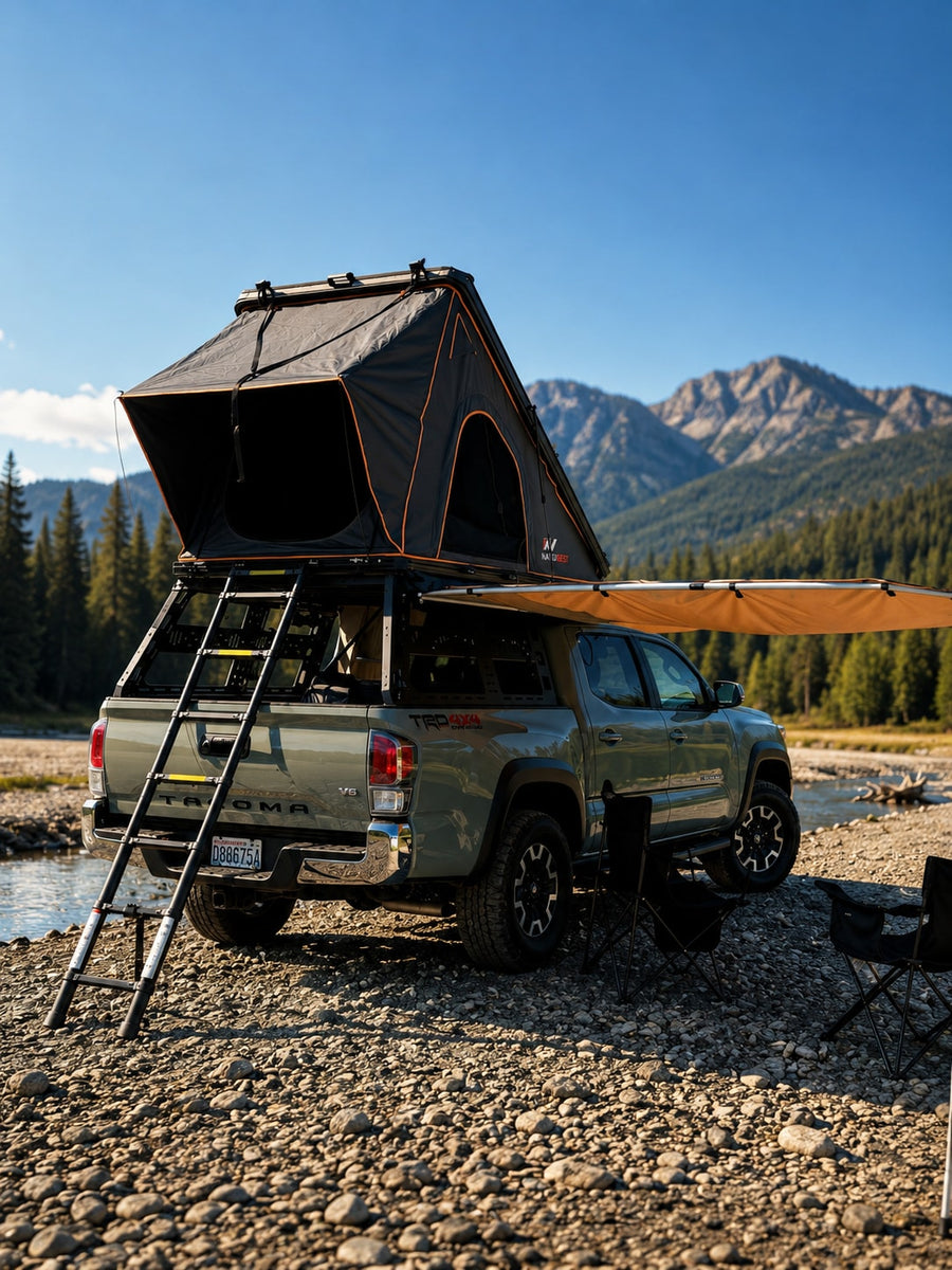 Olive truck with rooftop tent & awning by a rocky river. Great for off-grid camping; an RV rental adventure alternative.|Grey overlanding truck with rooftop tent parked in front of forested mountains. Great for outdoor trips
