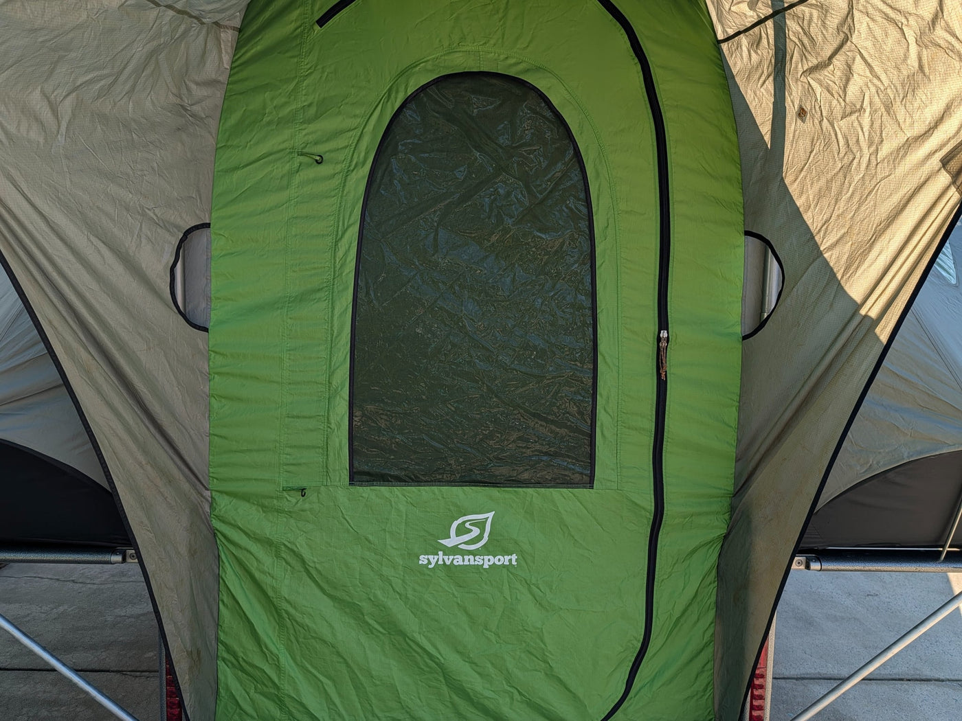 with a roof rack and open utility bed.|SylvanSport GO pop-up camper trailer for RV rental. Modern gray & green design with roof rack — photo 7