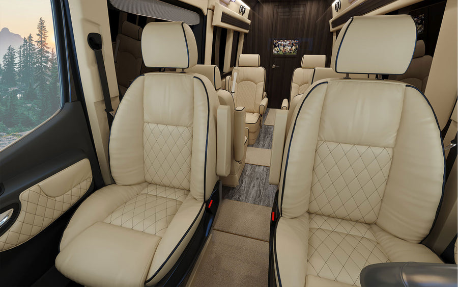 Spacious RV rental interior with plush cream leather seating and a TV