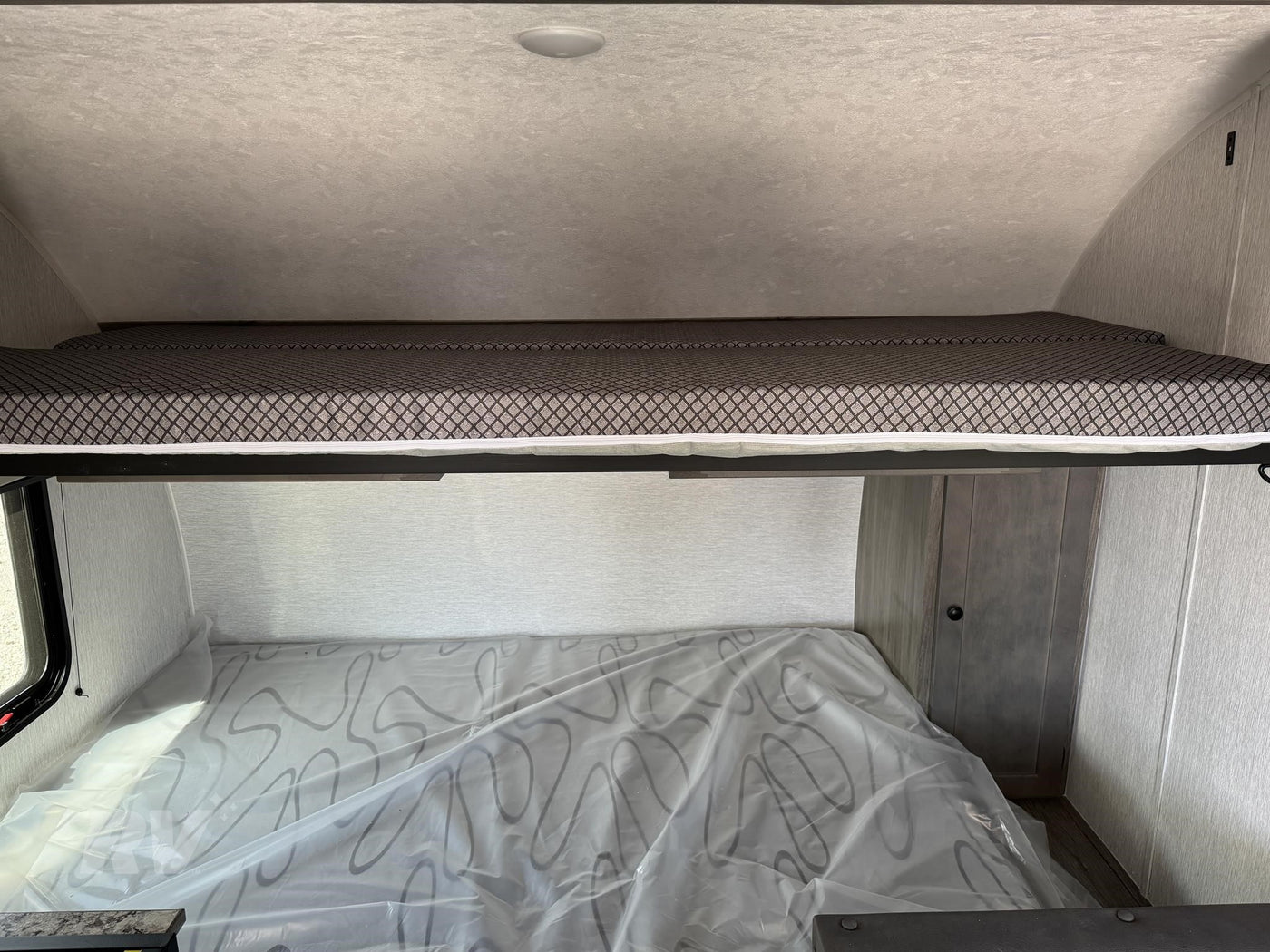 an ideal RV rental for outdoor adventures and camping trips.|RV rental: Upper bunk bed with patterned mattress — photo 2