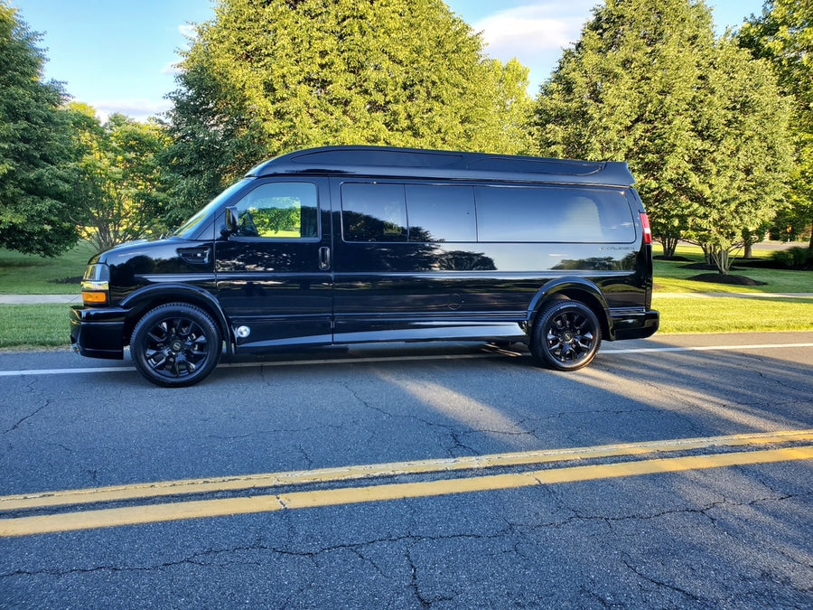 Sleek black custom Explorer conversion van for RV rental