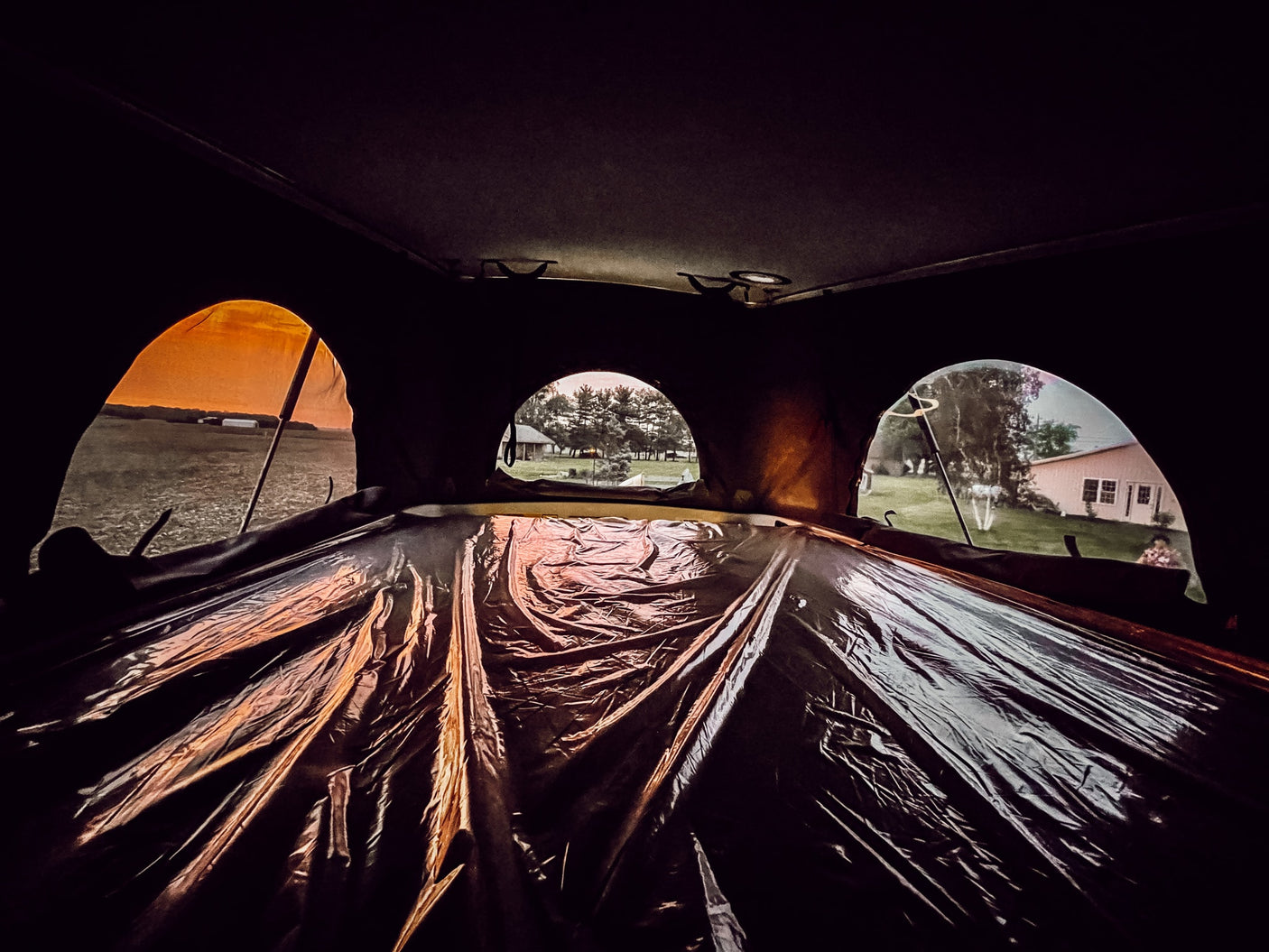 and panoramic windows for a cozy travel experience.|Cozy rv rental pop-top bed with grey quilted bedding
